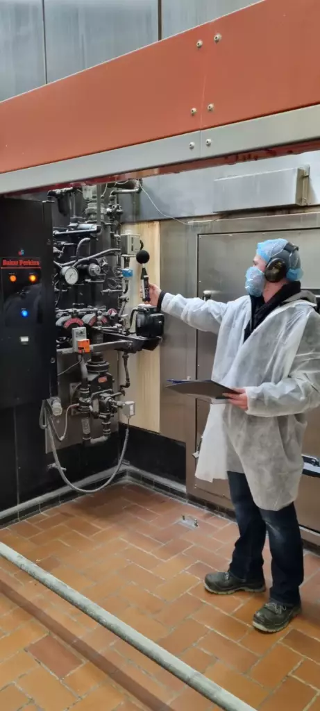 A man in a lab coat working on machinery